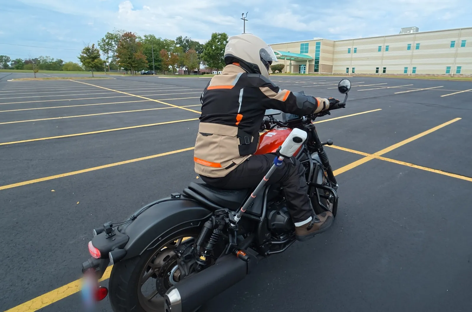 Rich on his Honda Rebel in an empty parking lot, with a camera on a stick fixed to the frame.